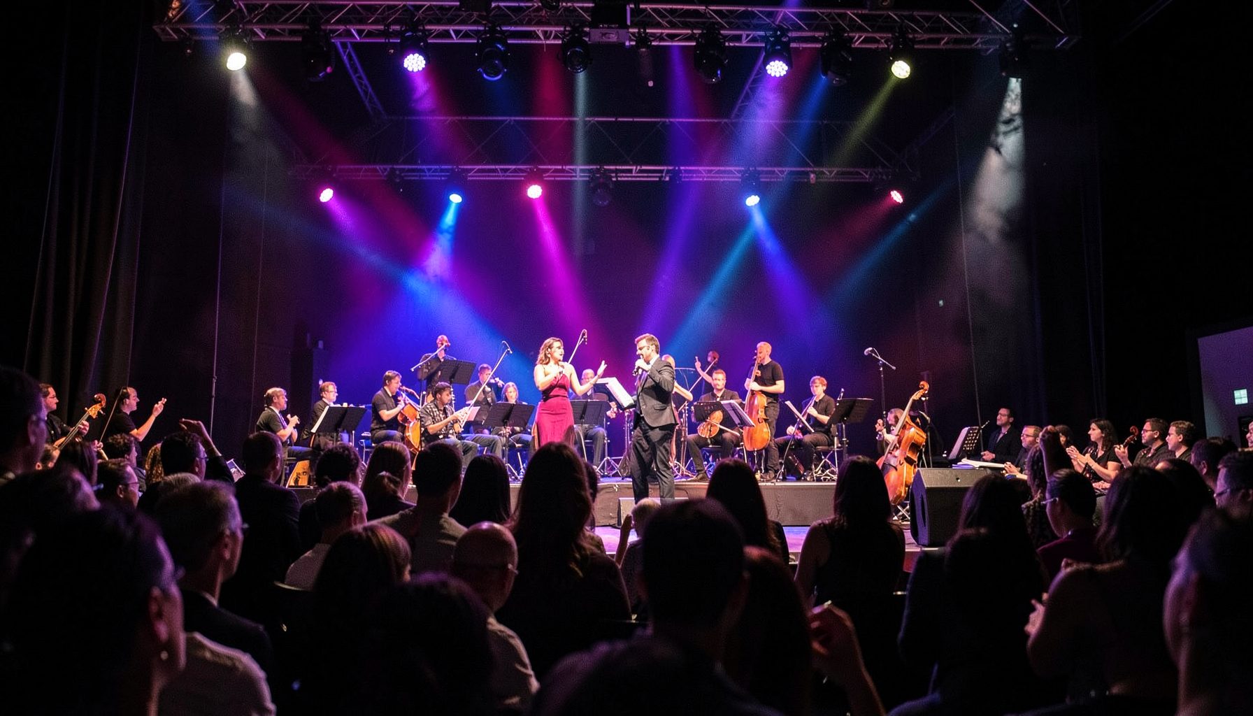 Cultural performance at a literary festival, vibrant stage lighting