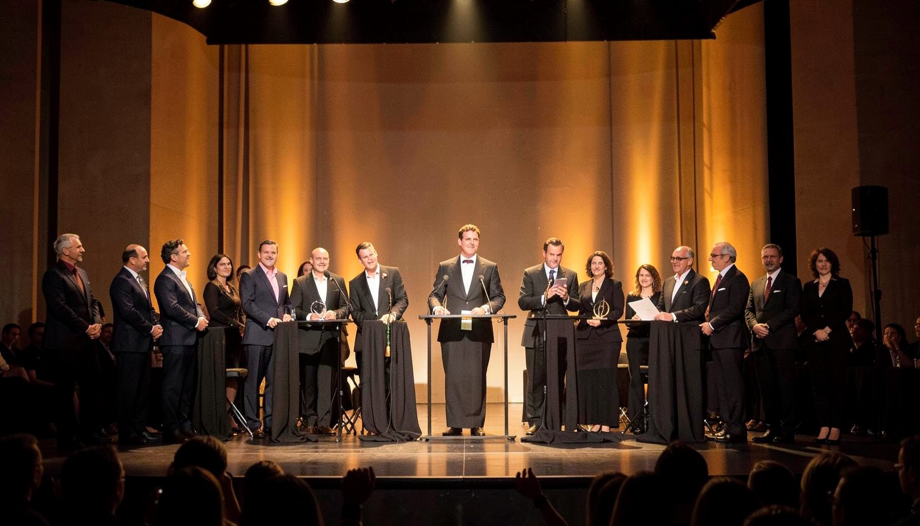 Literary award ceremony stage with dignitaries, warm golden lighting
